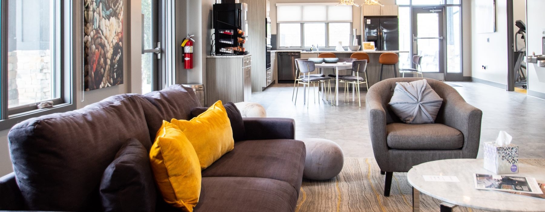 a clubroom with a couch, chairs and a table