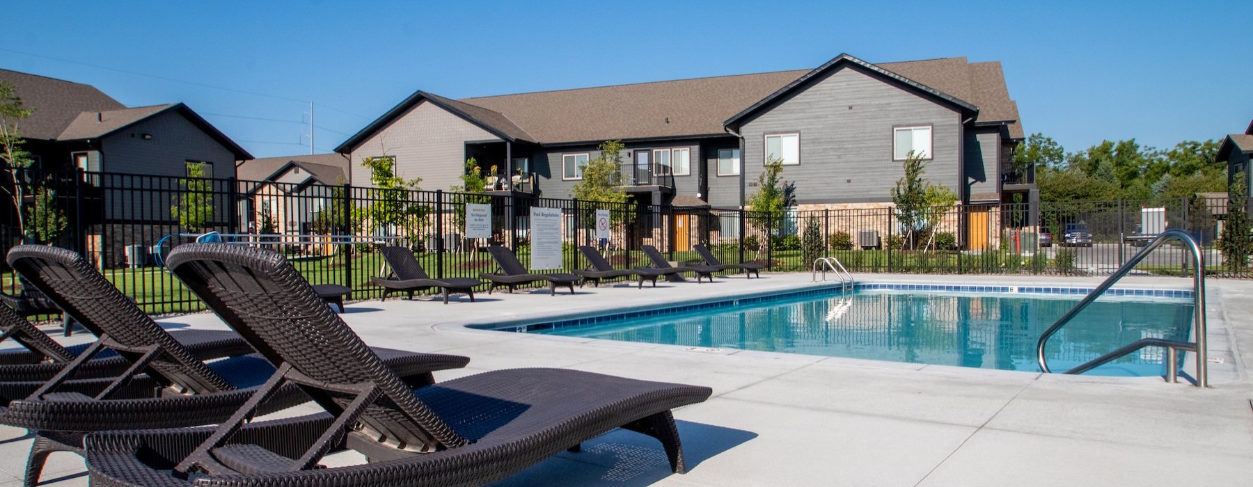 a swimming pool with chairs around it