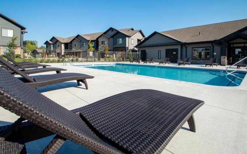a swimming pool with chairs around it